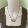 Gold tone kiss necklace Image 2