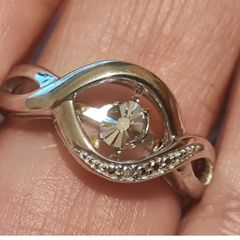 A 925 sterling silver ring with a floating diamond centerpiece.