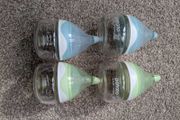 4 small glass baby bottles