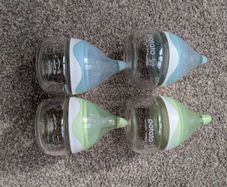 4 small glass baby bottles