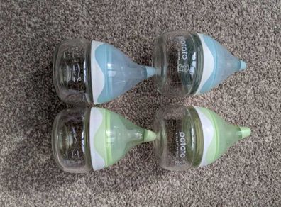 4 small glass baby bottles