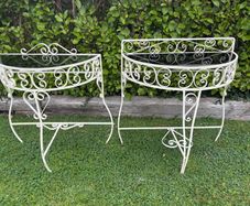 A vintage retro kitsch set of demilune weoght iron tables with glass toos c1950