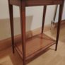 Small hardwood table with decorative inlaid border on both shelves. Image 3