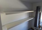 Two white floating shelves