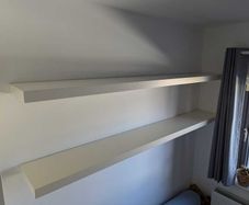 Two white floating shelves