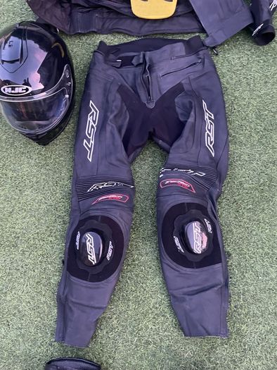 Motor cycle racing leathers with boots, gloves and helmet.