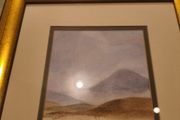 Gold framed picruer of land scape.