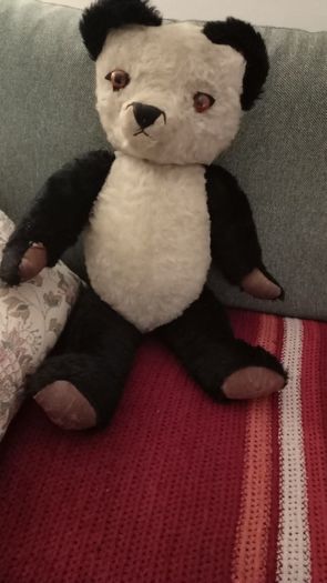 Antique straw-filled panda teddy bear