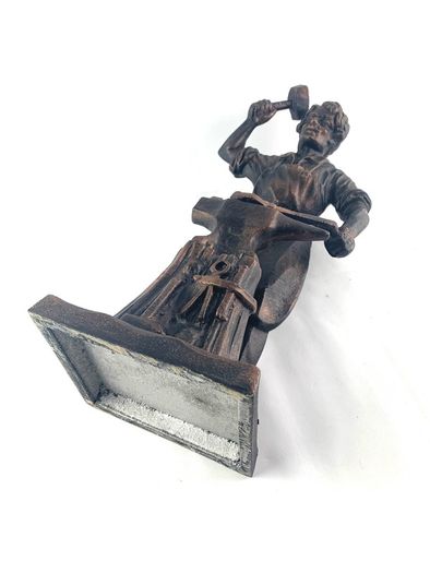 Vintage metal figurine of a blacksmith