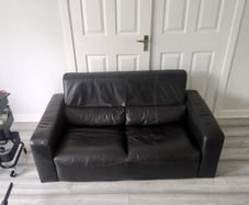 Free black two seater leather couch