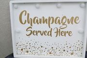 Lighting Up Champagne Sign
