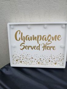 Lighting Up Champagne Sign