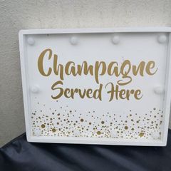 Lighting Up Champagne Sign