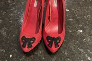 Red high heeled shoes with black lace