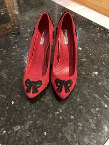 Red high heeled shoes with black lace