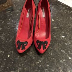 Red high heeled shoes with black lace