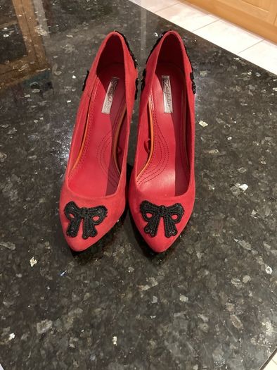 Red high heeled shoes with black lace