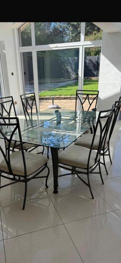 Glass dining table and 6 chairs (need gone today)