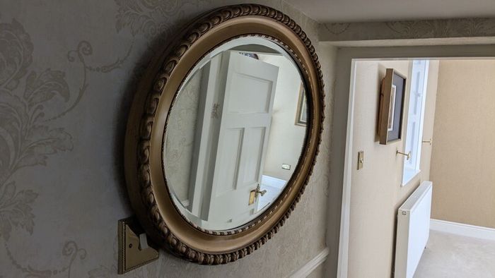 Ornate oval mirror