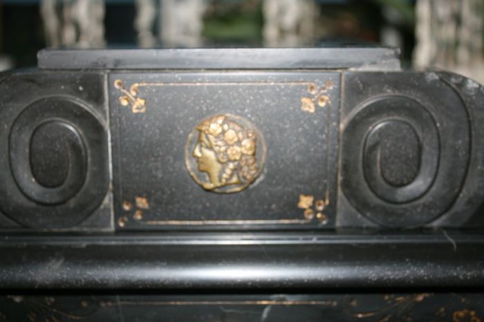 Victorian French Black Slate Mantle Clock (Very large and heavy) with bronze ornamentation Oversized. Open escarpment slate plate Roman numerals. Circa 1890s. Accented with Trojan head. Flanked by two Hellenistic ladies heads on sides. Rose cartouche mask