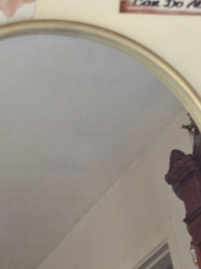 Beautiful Late 20th century Arched Brass Colored Metal Wall Mirror, the arched plate within tubular uprights with spherical finials. Collection is Preferred