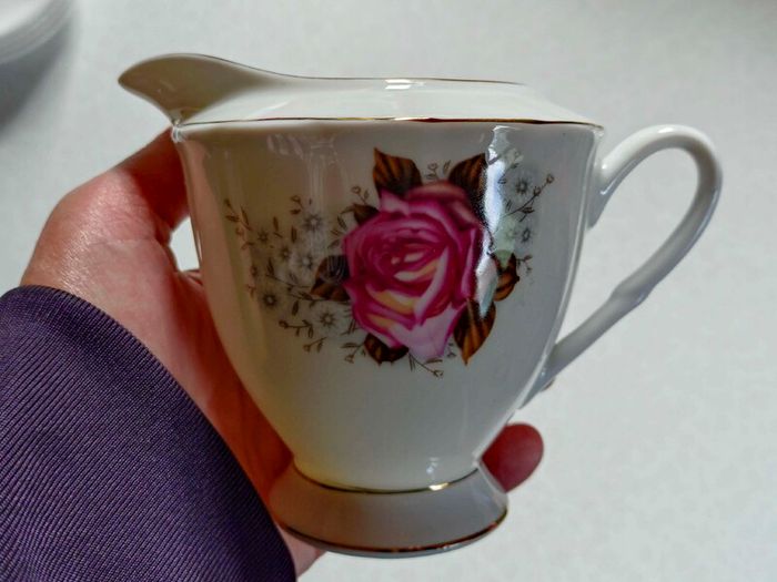 Milk Jug & 4 Saucers (used).