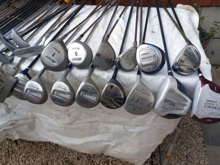 A selection of Golf clubs. Bags and golf balls.