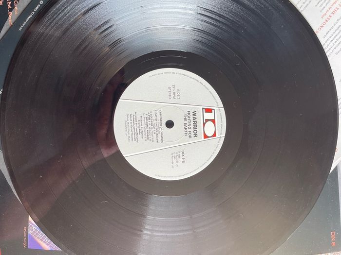 WARRIOR Fighting for the earth original 1985 release with inner lyric sheet vinyl record in near mint condition. Sleeve is vg with just some light wear along top of spine otherwise it would be nm