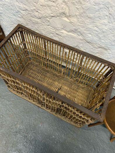Large Victorian cane and metal laundry basket on wheels.