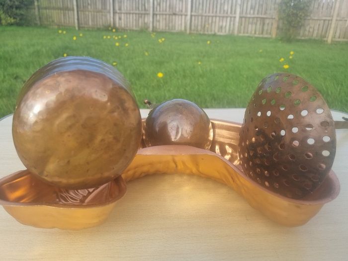 Vintage-style copper cookware and kitchen accessories.