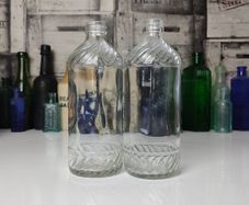 328 - Set of 2 Vintage Clear Glass Collectible Decorative Swirls Bottles