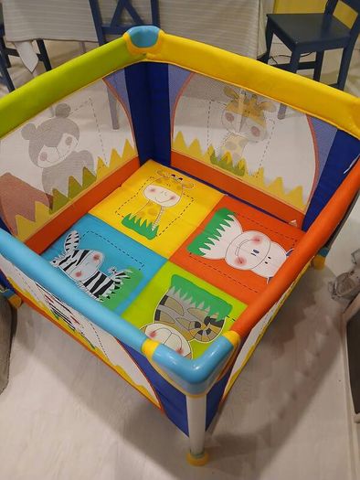 Bright and colorful square baby playpen featuring a cheerful animal safari theme.