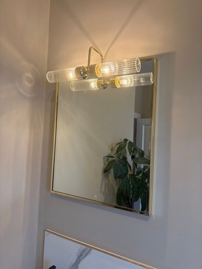 Gold framed mirror with integrated light vanity