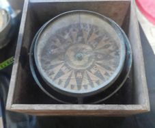 Antique Large Ships Nautical Compass, models were produced by firms like Francis M. Moore Dublin & Belfast active 1854 to 1894 or Henry Hughes & Son of London., as indicated by the style of the compass rose and the gimbaled mounting in a wooden bo