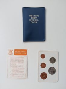 Britain's first decimal coins set in a blue wallet