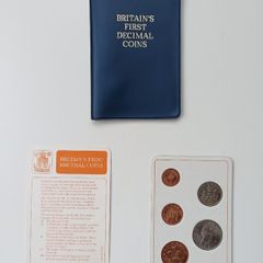 Britain's first decimal coins set in a blue wallet