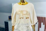 stunning elephant embroidery to the lightweight, textured drape and split-sleeve design this top is a wardrobe must-have.