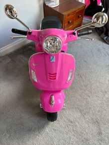 Pink electric Vespa motorbike