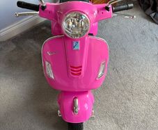 Pink electric Vespa motorbike