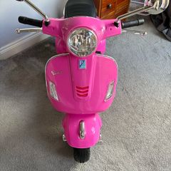 Pink electric Vespa motorbike