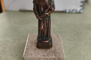 Copper Sacred art statue of Saint Francis of Assisi on marble plinth.