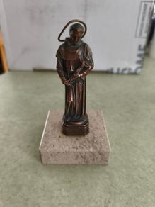 Copper Sacred art statue of Saint Francis of Assisi on marble plinth.