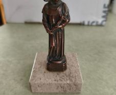 Copper Sacred art statue of Saint Francis of Assisi on marble plinth.