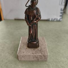 Copper Sacred art statue of Saint Francis of Assisi on marble plinth.