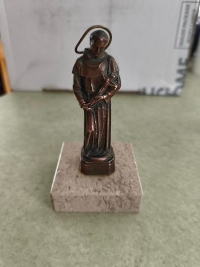 Copper Sacred art statue of Saint Francis of Assisi on marble plinth.
