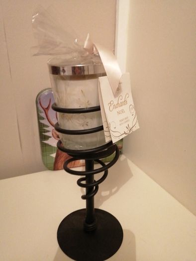 candle with wrought-iron holder.