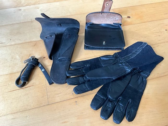 Vintage military-style black leather gear, likely representing a pistol holster, ammunition pouch