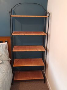 Black metal frame with wicker shelves