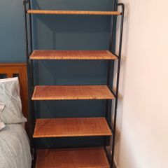 Black metal frame with wicker shelves