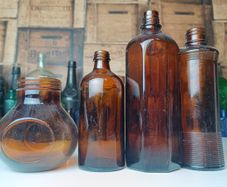484 - Set of 4 Vintage Brown Amber Glass Screw Top Collectible Decorative Bottles